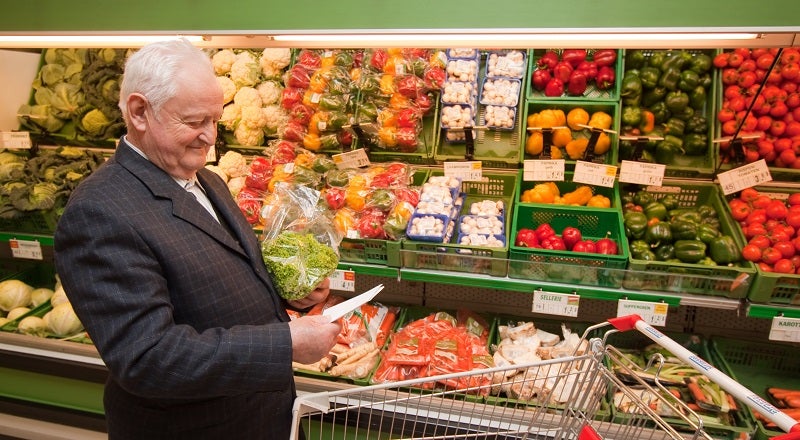 Man with trolley in supermarket