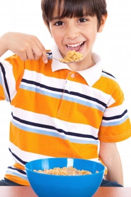 child eating cereal, white background