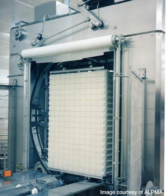 The Saratoga Cheese Corporation plant in New York will house equipment such as this automatic stack turner for block-form stacks.